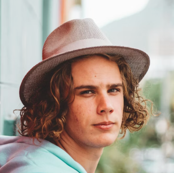 Young man wearing fedora hat.